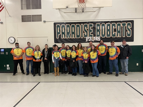 Group of junior high staff wearing tie dye shirts that say 